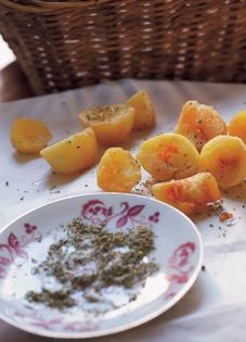 Fried potato halves with oregano