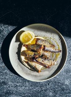 Fried sardines, sunflower tarator, and lemon