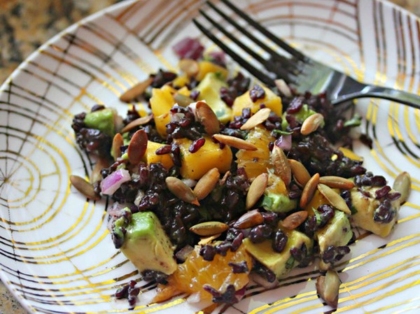 Fruity black rice salad with cilantro, avocado, and pepitas in chili-orange vinaigrette