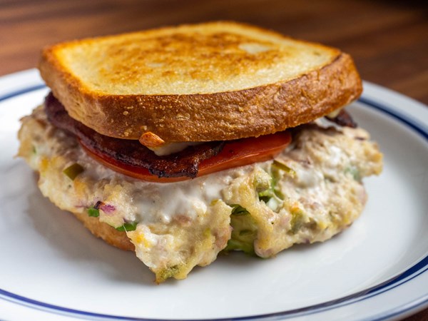 Fully loaded tuna melt with bacon, pickled peppers, avocado, and tomato