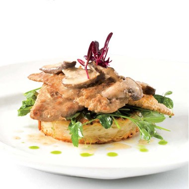 Gardein "chicken" scaloppini with shiitake sake sauce, braised pea shoots, and crispy udon noodle cakes