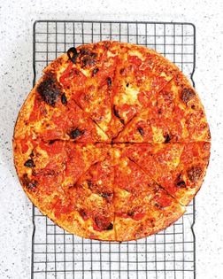 Garlic, caramelized onion, anchovy and breadcrumb Sicilian pizza