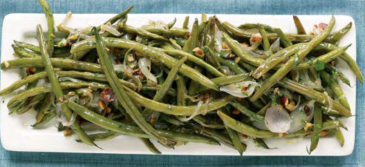 Garlic-roasted green beans and shallots with hazelnuts
