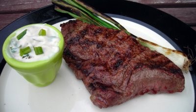Garlic rubbed steak with grilled spring onions and a creamy spring onion sauce