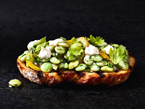 Garlic toasts with lemon aioli and marinated beans