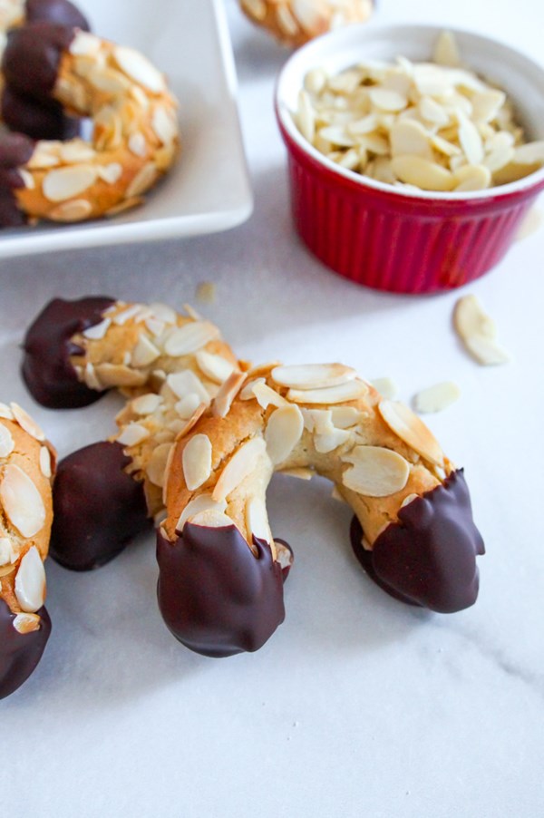 German chocolate-dipped almond horn cookies (Mandelhörnchen)