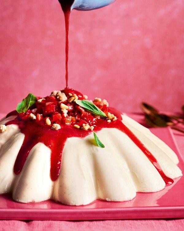 Giant yogurt pannacotta with strawberries, basil and pine nuts