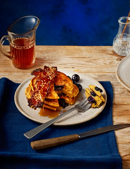 Ginger and blueberry pancakes with gochujang-glazed bacon and maple syrup
