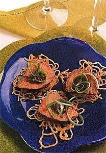 Ginger-hoisin beef and scallions on crispy noodle cakes