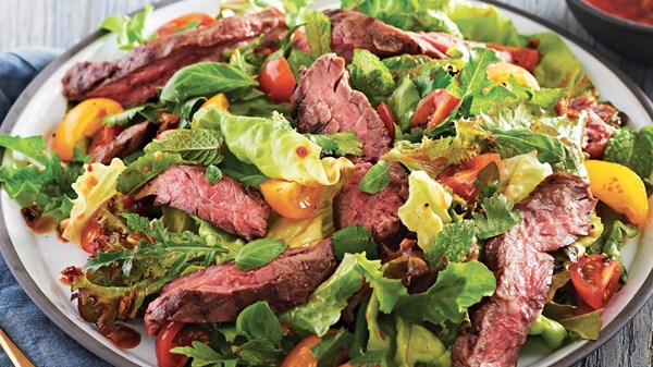 Ginger-soy skirt steak salad with basil, mint, and cilantro