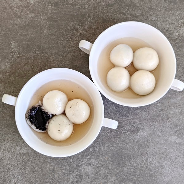 Glutinous rice balls with black sesame filling in ginger soup
