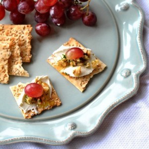 Goat cheese and grapes on flat bread with rosemary-walnut drizzle