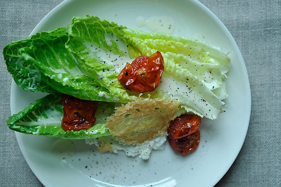 Goat cheese Caesar salad with roasted tomatoes and Parmesan crisp
