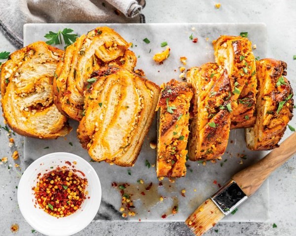 Goat cheese-harissa babka [harissa filling; hot honey syrup]