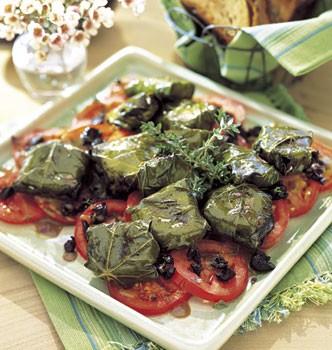 Goat cheese in grape leaves with tomato and olive salad