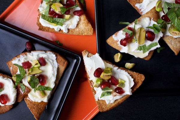 Goat cheese pita toasts with pomegranate, pistachio and mint