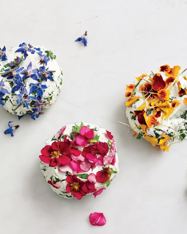 Goat cheese with edible flowers and arugula