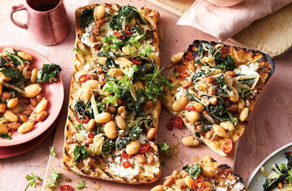 Goat's cheese crostini with garlicky beans and silverbeet