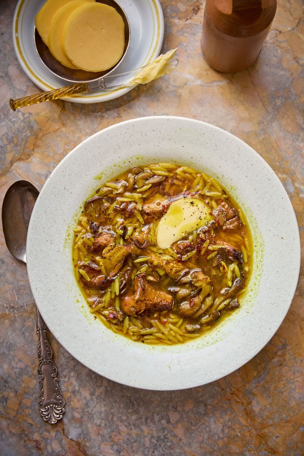 Golden mushroom soup with orzo and a pat of butter