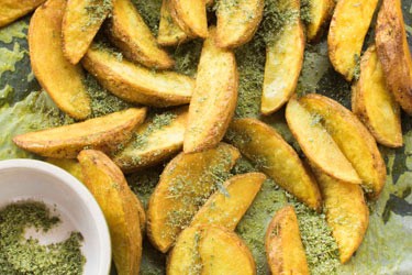 Golden potato wedges with rosemary and thyme herb salt