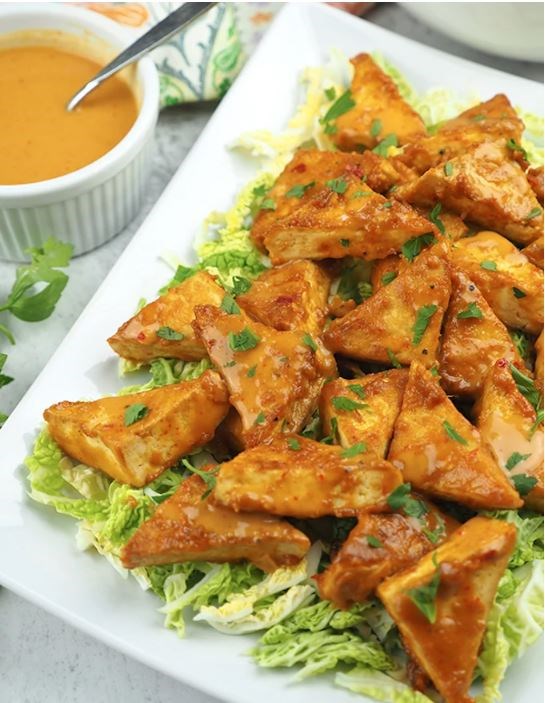 Golden tofu triangles with rich peanut sauce
