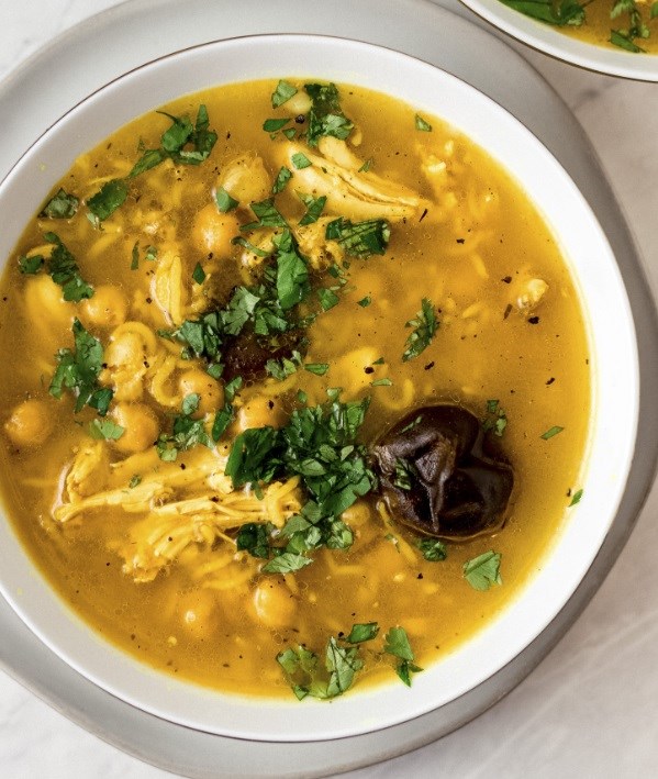 Golden turmeric chicken soup with dried lime