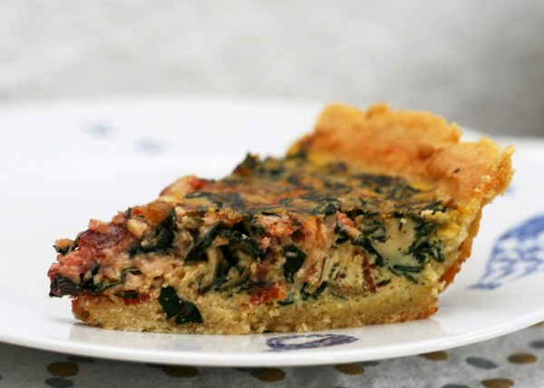 Goose egg quiche with beet greens and bacon and a Parmesan-pepper crust