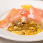 Grana Padano cheese, confit onion & potato gratin with prosciutto di San Daniele
