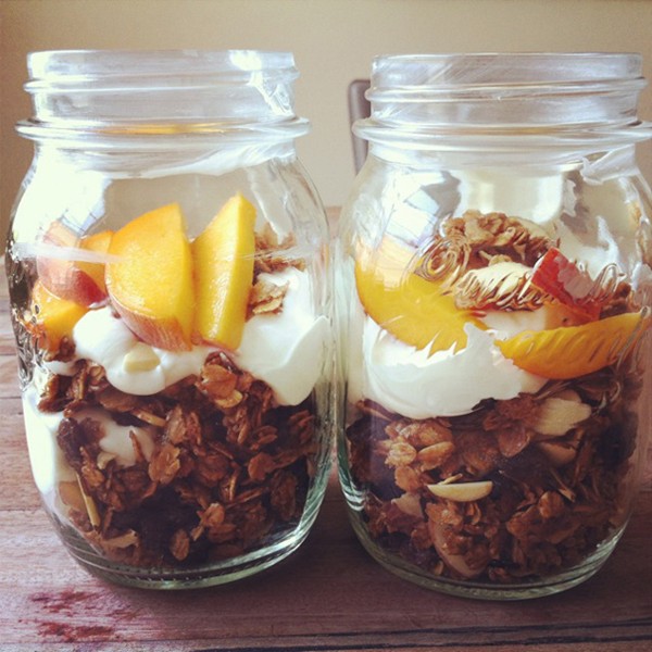 Granola, yogurt, and peach parfaits in Mason jars