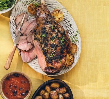 Greek-style roast lamb & new potatoes with tomato, olive sauce