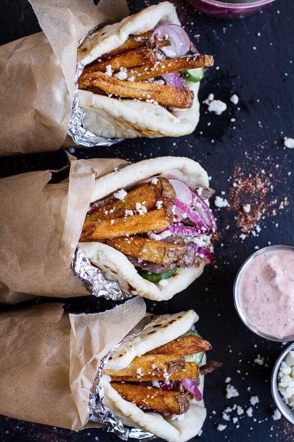 Greek style roasted lamb gyros with harissa spiced tzatziki