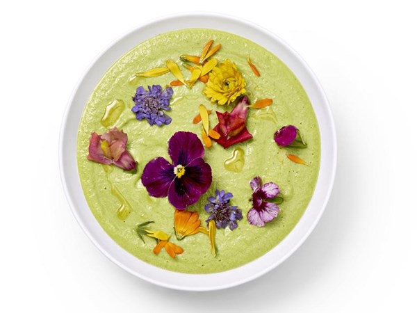 Green gazpacho with edible flowers