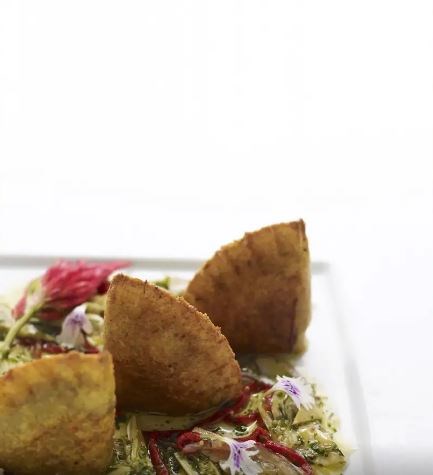 Green plantain empanadas with spinach-Manchego filling and artichoke escabeche