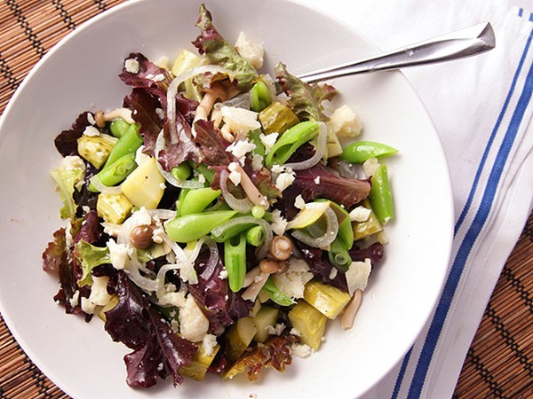 Green salad with pickled mushrooms, cucumbers, onions, and pecorino