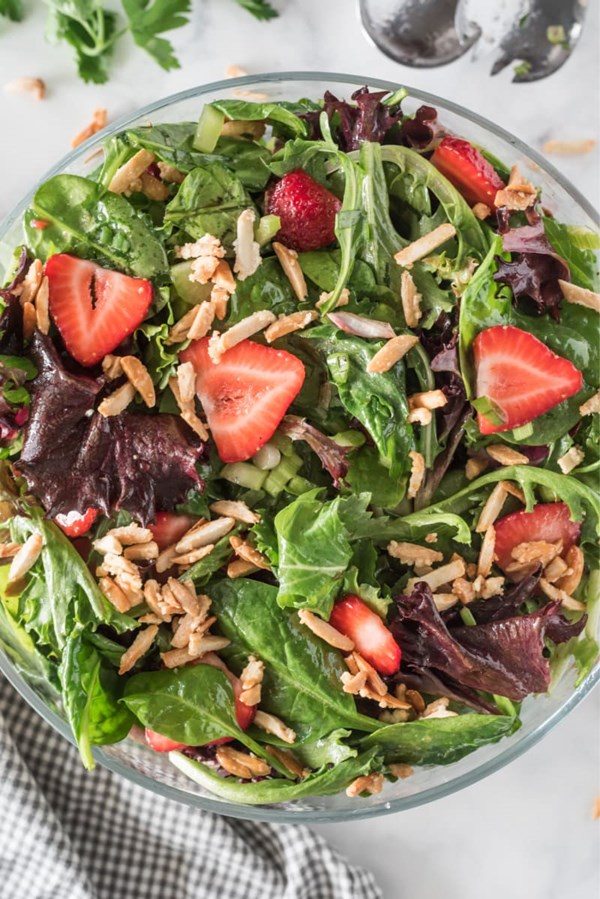 Green salad with strawberries and slivered almonds