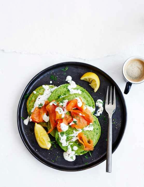 Green spinach pancakes with soured cream, smoked salmon and dill