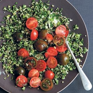 Green tabbouleh topped with a cherry tomato salad