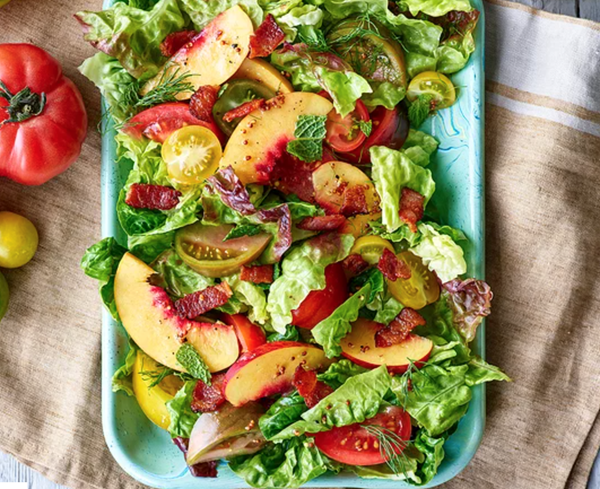 Greens with tomatoes, peaches & raspberry vinaigrette
