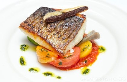 Griddled sea bass with stuffed courgettes, tomatoes, olives and basil