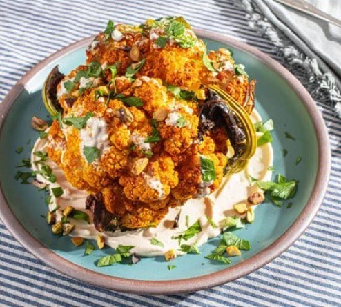 Grill-roasted whole cauliflower with tahini-yogurt sauce