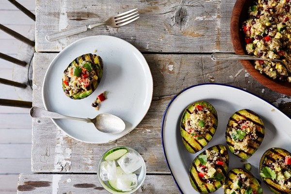 Grilled avocado halves with cumin-spiced quinoa and black bean salad