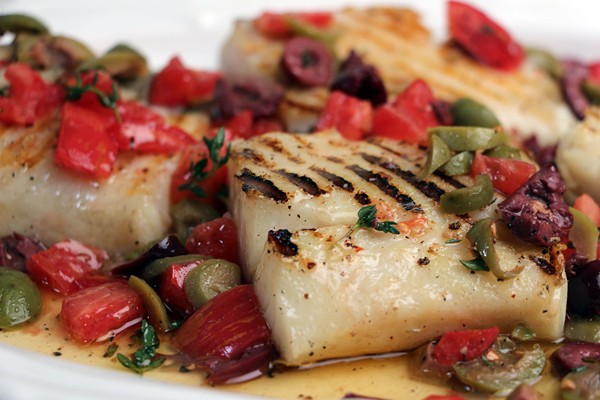 Grilled bacalao (salt cod) steaks with olive sauce
