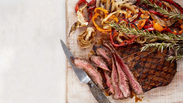 Grilled balsamic flank steak with peppers and onions