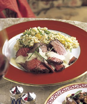 Grilled beef tenderloin with roasted garlic sauce and leek-tomato quinoa