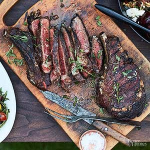 Grilled bone-in beef ribeye steak