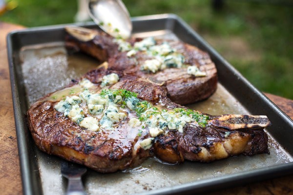 Grilled bone-in rib-eye steaks with blue cheese