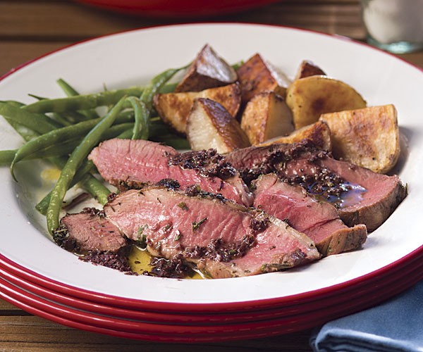 Grilled boneless leg of lamb with black olive purée