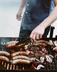 Grilled brats and onions with parsley sauce