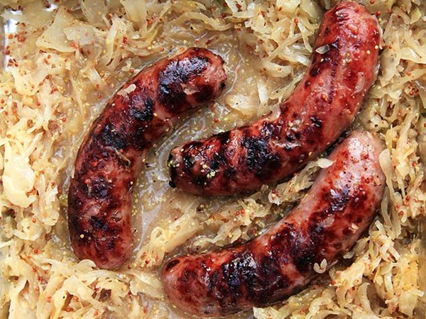 Grilled bratwurst with beer, mustard, and sauerkraut