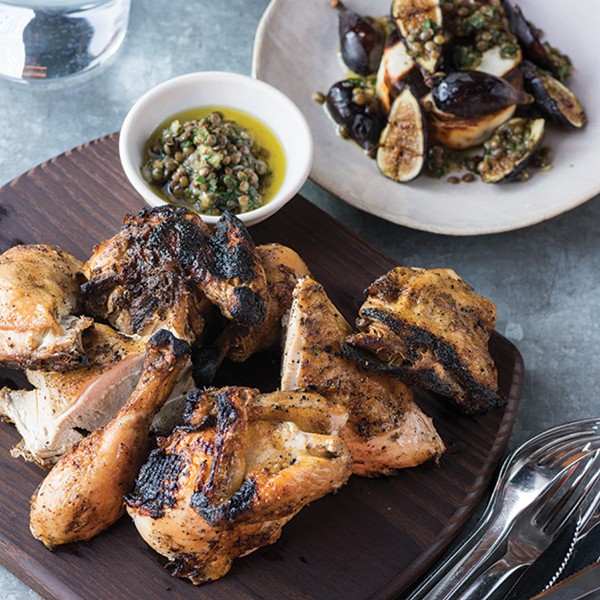 Grilled butterflied whole chicken with grilled figs, manouri cheese, and lentil chimichurri